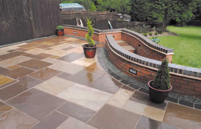 Expansive curved patio with raised walls and potted tree