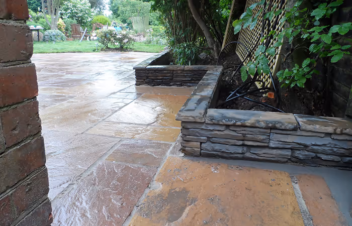 Sandstone patio with raised stone bed