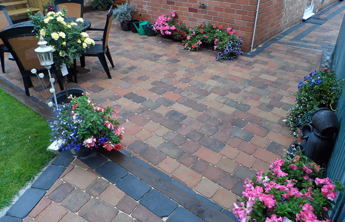 Block paving with pots and colourful planting