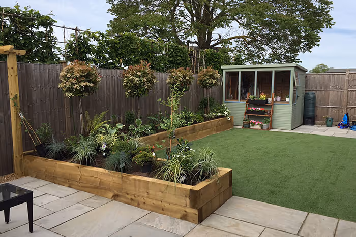 Raised timber sleeper beds with lawn